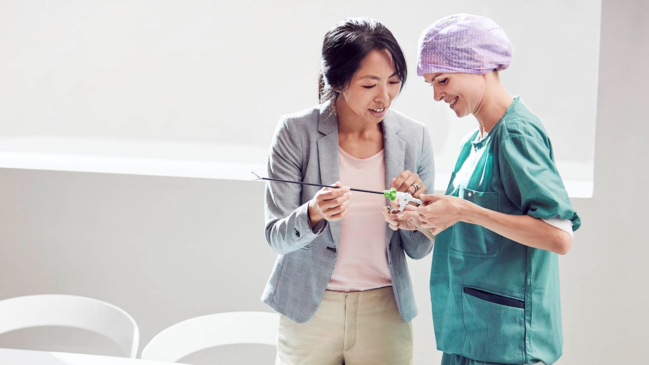 suppliers demonstrates a surgical instrument to a healthcare professional